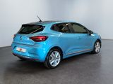 the rear end of a blue car parked in a room