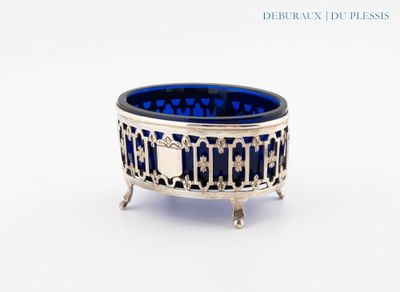 a close up of a silver and blue bowl on a white surface