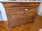 a wooden dresser with a marble top in a room