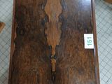 a small wooden table with a clock on top of it