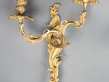 pair of antique wall sconces with two candles on each of them