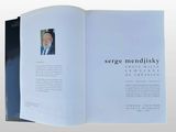 an open book with a picture of a man in a suit and tie