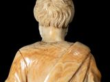 marble statue of a man with his back turned to the camera