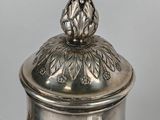 silver plated coffee pot with a lid and a flower decoration