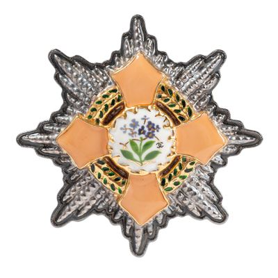 un gros plan d'une broche ornée d'une fleur
