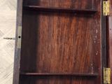 a small wooden box with a door open on the floor