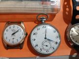 three watches sitting next to each other on a table