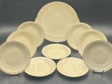 a group of white and yellow dinner plates with dots on them