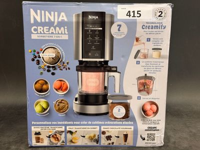 a box that has a blender in it on a table