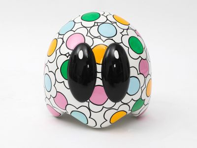 a close up of a colorful ball with black eyes