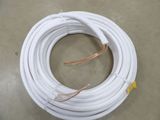 a coil of white electrical wire sitting on top of a floor