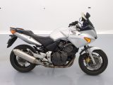 a picture of a white motorcycle parked in a room