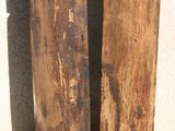 two pieces of wood sitting next to each other on the ground