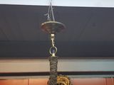 a clock hanging from the ceiling in a room