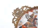 a clock with a picture of a man riding a horse on it