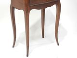 a small wooden table with a drawer on top of it