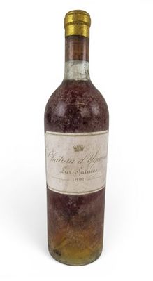 a bottle of wine sitting on top of a white surface