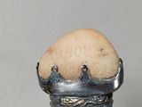 an egg sitting on top of a silver ring
