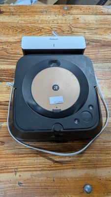 a black record player sitting on top of a wooden table