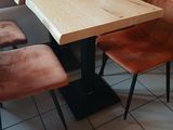 a table with four chairs and a bench in a room