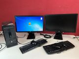 un ordinateur de bureau posé sur une table avec un clavier et une souris