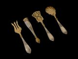 five silverware spoons and a fork on a black background
