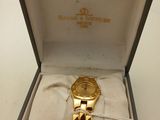an image of a watch in a box on a white surface