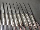 a lot of knives that are sitting on a table