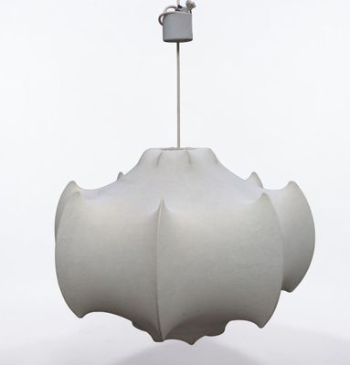 a white object hanging from a metal hook on a pole