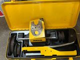 a tool in a yellow case on the floor