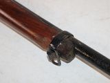 a gun that is on a table with a wooden handle