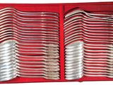 many spoons and forks in a red box