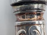 a close up of a silver object on a table