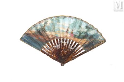 a fan with a painting on it sitting on a table