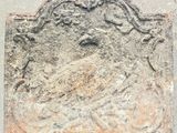 an image of a stone plaque with a bird on it