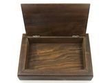 an open wooden box sitting on top of a white surface