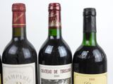 three bottles of wine are lined up on a table