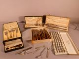 many different types of silverware on a table
