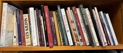 many books on a wooden shelf in a room