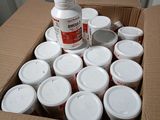 a cardboard box full of pills and a bottle of medicine