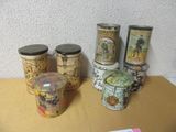 four tins sitting on a table next to each other