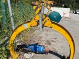 a blue ball laying on the ground next to a yellow bulldozer