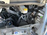 the engine compartment of a car with its hood open and the hood open