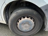 a flat tire on the side of a white car