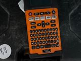 an orange cell phone sitting on top of a black case