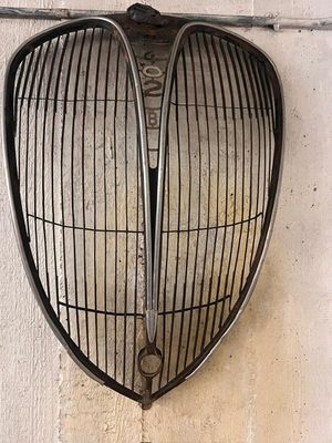 a metal grill hanging on the side of a wall