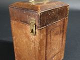 a small wooden box with a handle on a table