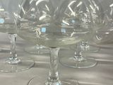 six wine glasses sitting on a table with a white background