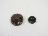 a small coin and a smaller coin on a white surface