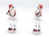 two figurines of a man and a woman dressed in costumes